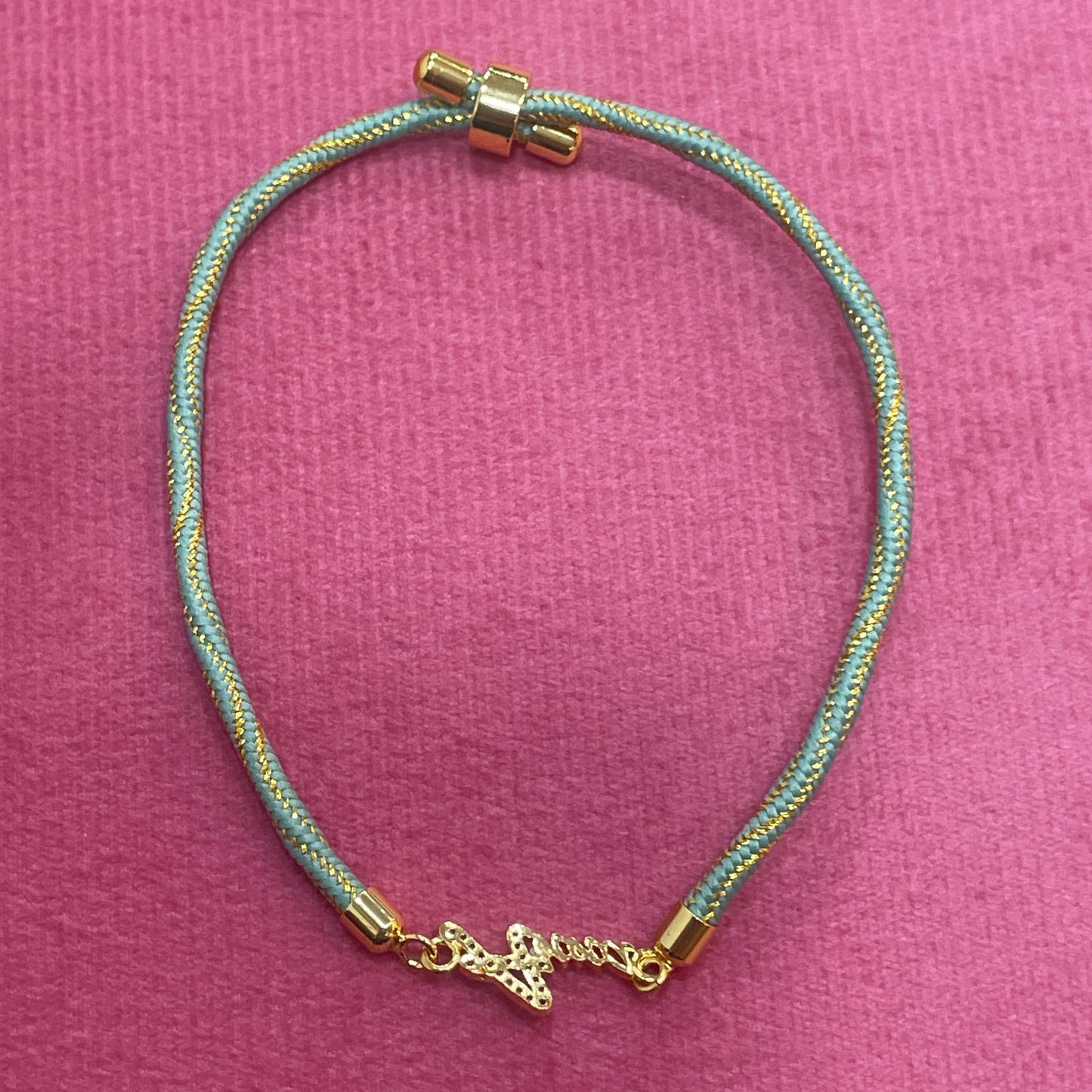 Gold-Plated Name Rakhi for Brother | CZ Script Charm on Teal & Gold Twisted Thread