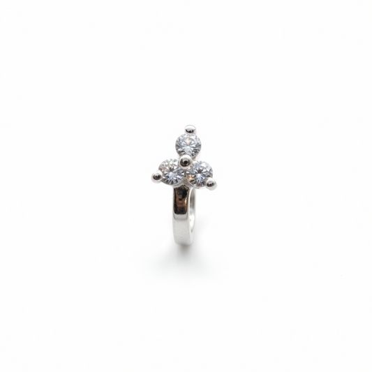 Gold ring with a diamond on a finger against a blue background