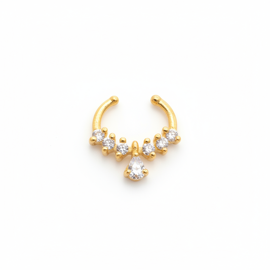 Gold nose ring with small diamonds on a teal textured background