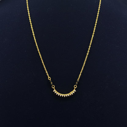 Gold necklace on a red fabric background