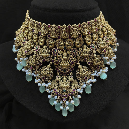 Decorative gold and pearl headpiece on a pink fabric background