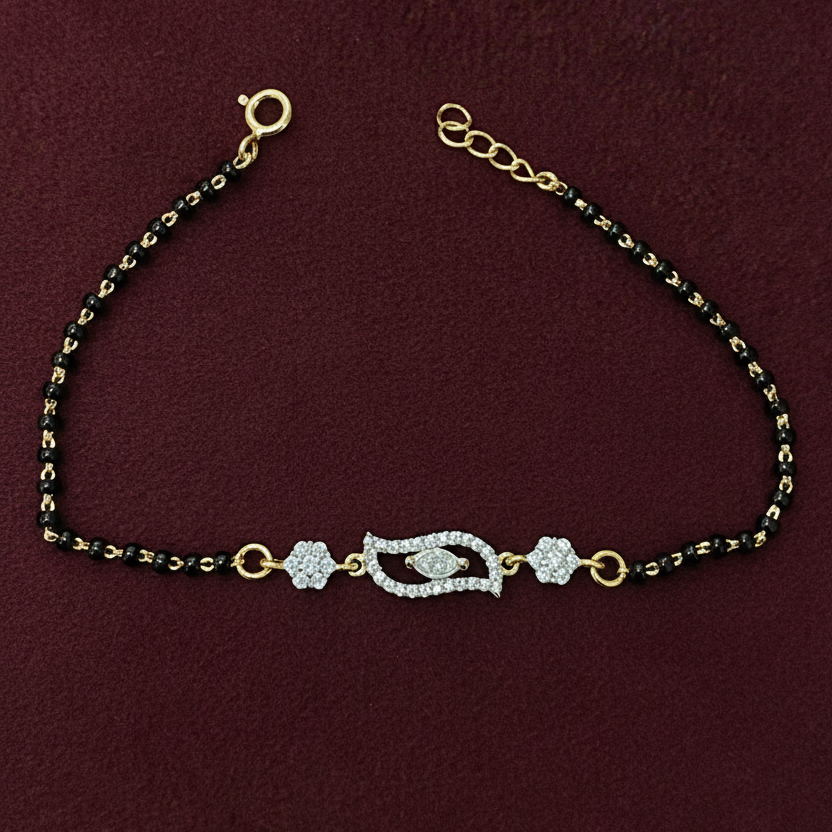 Decorative necklace with black beads and gold accents on a red background