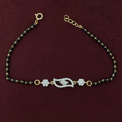 Decorative necklace with black beads and gold accents on a red background