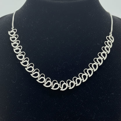 Silver necklace on a red textured surface