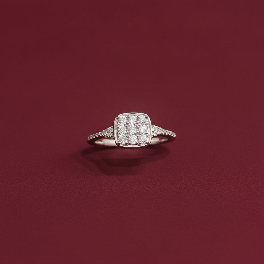 Diamond ring on a teal fabric background with red fabric partially covering it