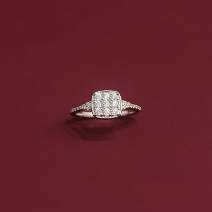 Diamond ring on a teal fabric background with red fabric partially covering it