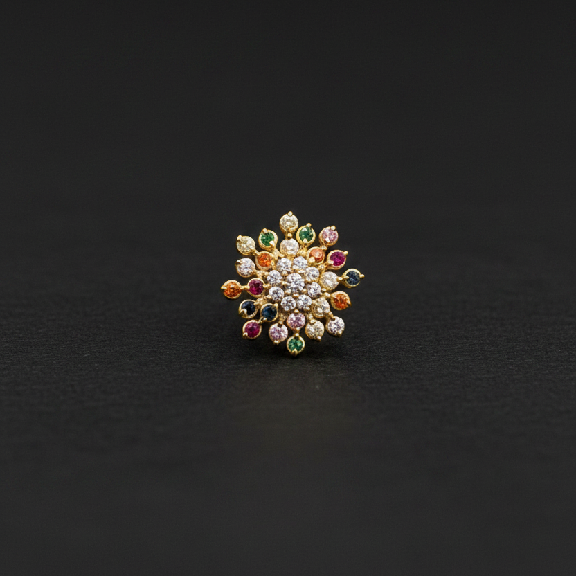 Multicolored gemstone ring on a hand with a red fabric background