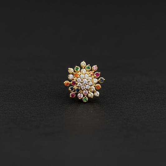 Multicolored gemstone ring on a hand with a red fabric background