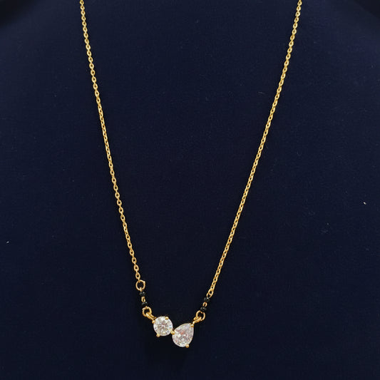 Gold necklace with diamond-like beads on a red velvet surface