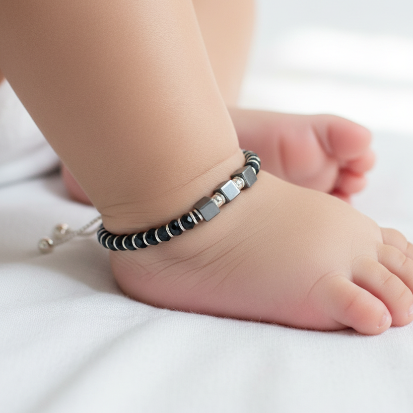 Baby's foot wearing a bracelet on a white background