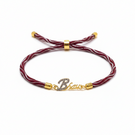 Gold-Plated Bhaiya Name Rakhi for Brother | CZ Script Charm on Maroon & Gold Twisted Thread