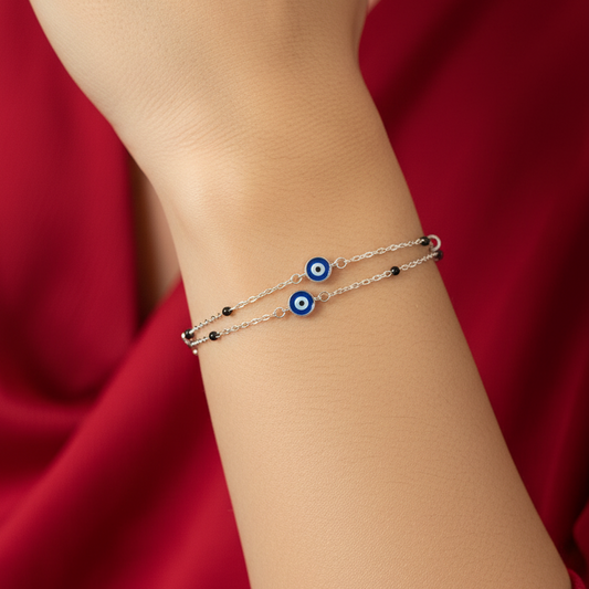 Silver bracelet with blue stones on a black jewelry box against a red fabric background