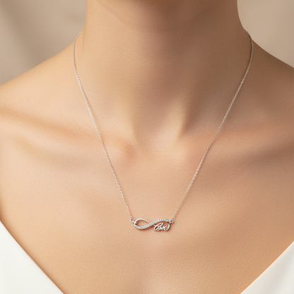 Silver necklace with a heart pendant in a black jewelry box on a red fabric background