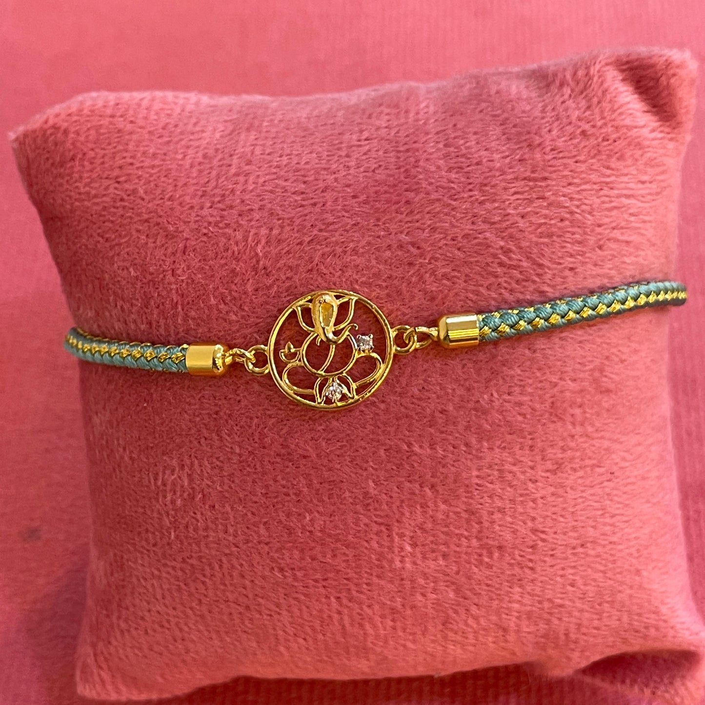 Silver Ganesha Rakhi for Brother | Gold Plated Ganesh Charm with CZ Stones on Teal Thread