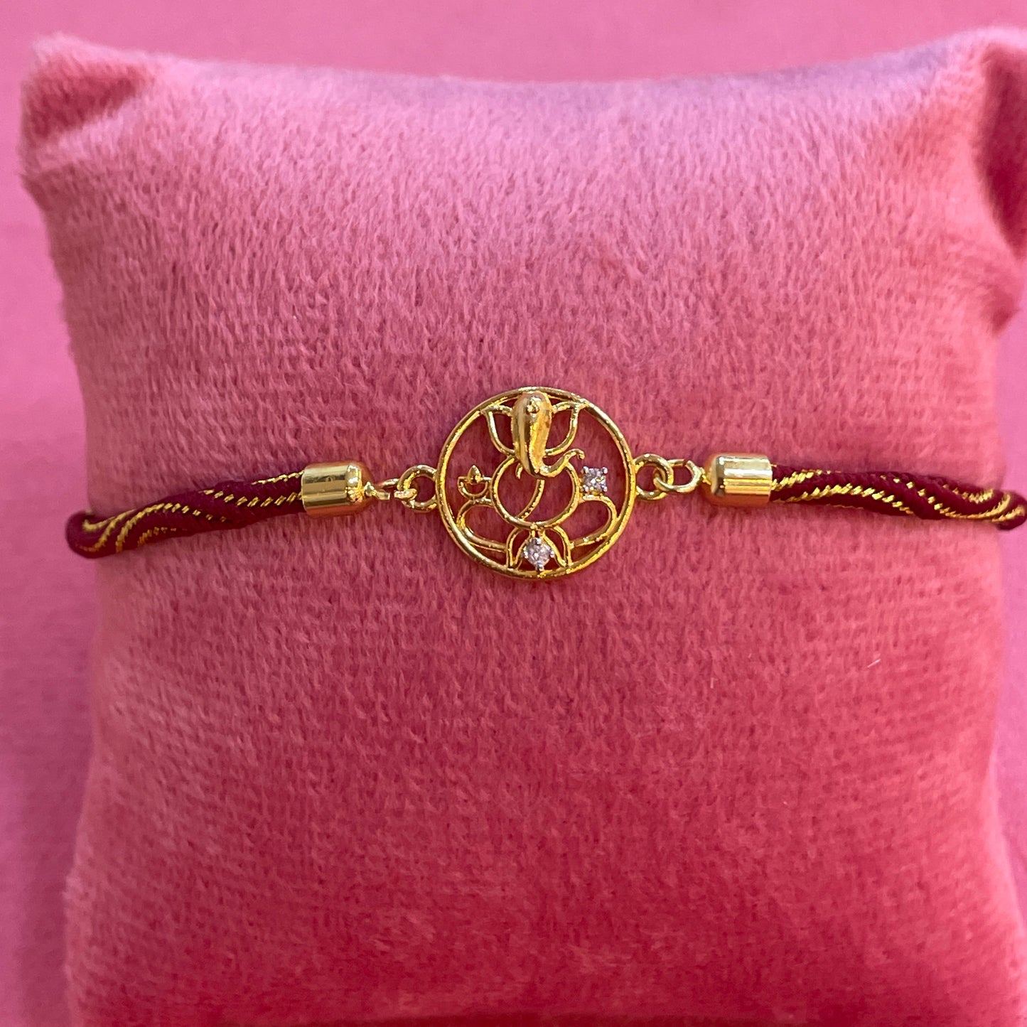 Gold Plated Ganesha Rakhi for Brother | Circular Cutwork Motif with Maroon Thread