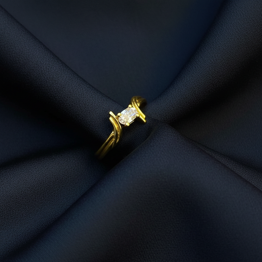 Gold ring on a textured red fabric background