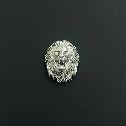Silver lion head emblem on red fabric