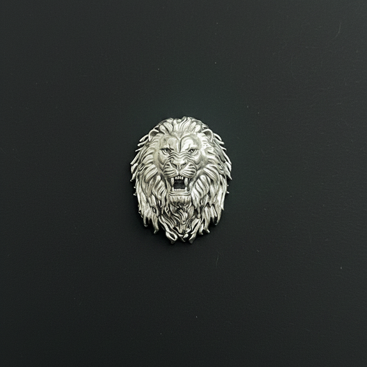 Silver lion head emblem on red fabric