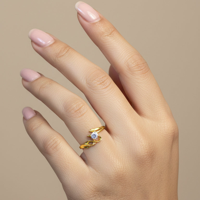 Gold ring with a diamond on a finger against a red fabric background