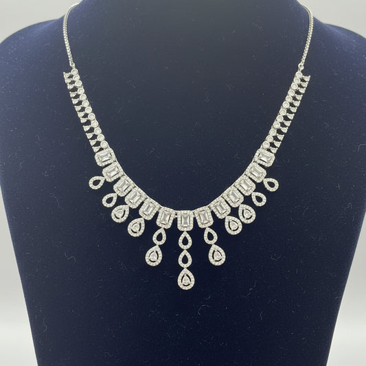 Silver necklace on a red fabric background