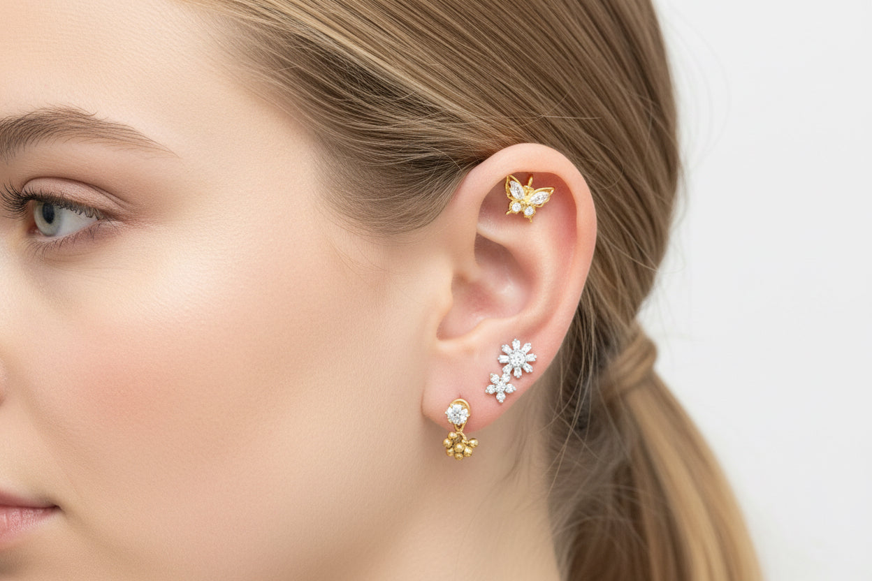 Close-up of a woman's ear wearing floral earrings with a neutral background