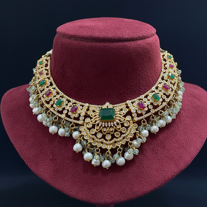 Decorative brooch with gemstones on a pink fabric background