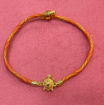 Gold-Plated Rakhi for Brother | Lucky Tortoise Charm on Orange Silk Thread