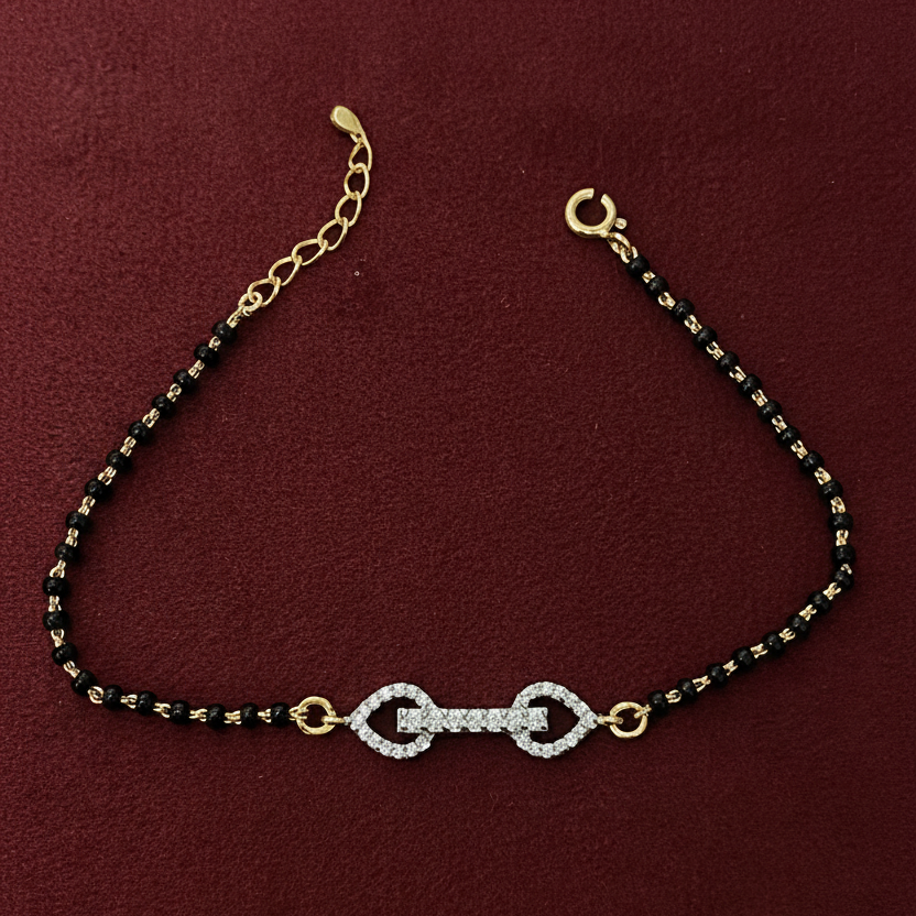 Bracelet with black beads and gold accents on a red background