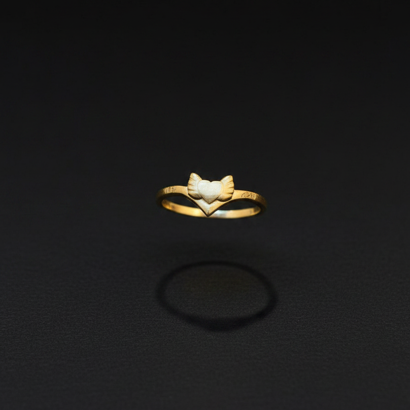 Gold ring with a leaf design on a finger against a red fabric background