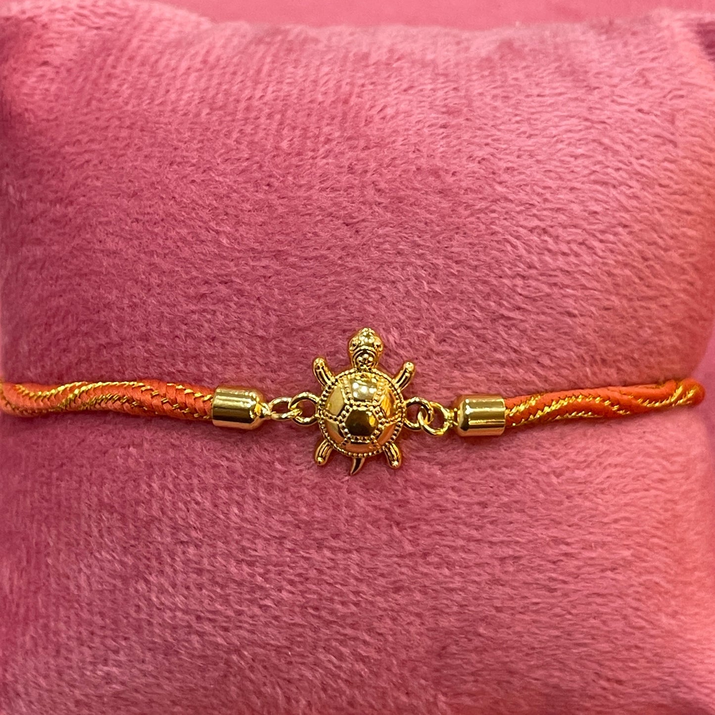 Gold-Plated Rakhi for Brother | Lucky Tortoise Charm on Orange Silk Thread