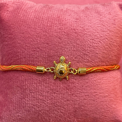 Gold-Plated Rakhi for Brother | Lucky Tortoise Charm on Orange Silk Thread