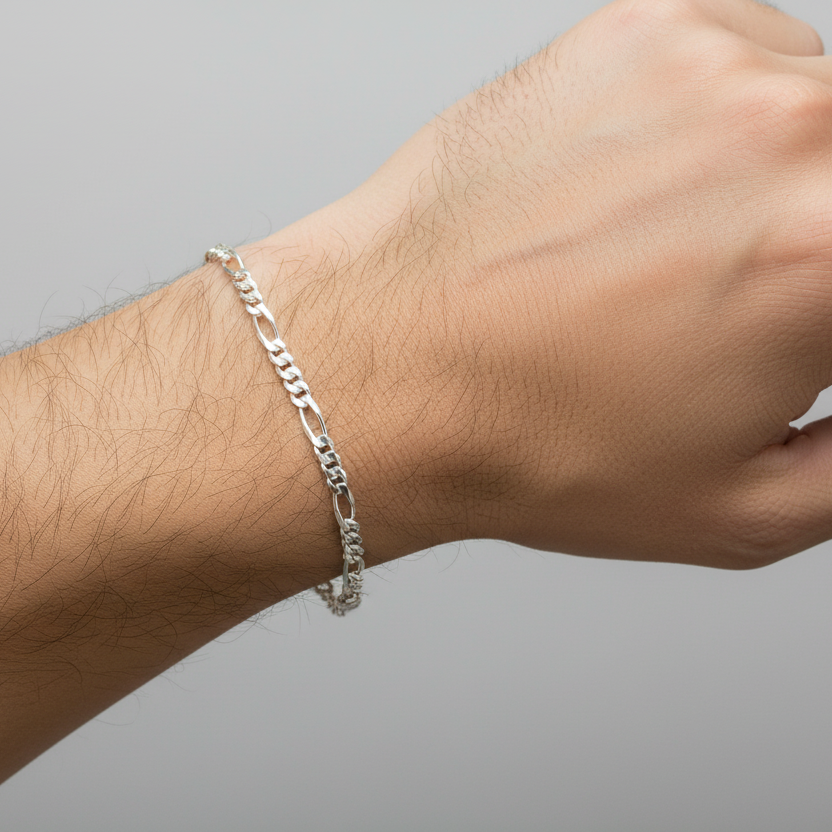 Silver bracelet on a wrist against a gray background