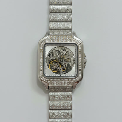 Silver watch with diamond-studded band on a red fabric background