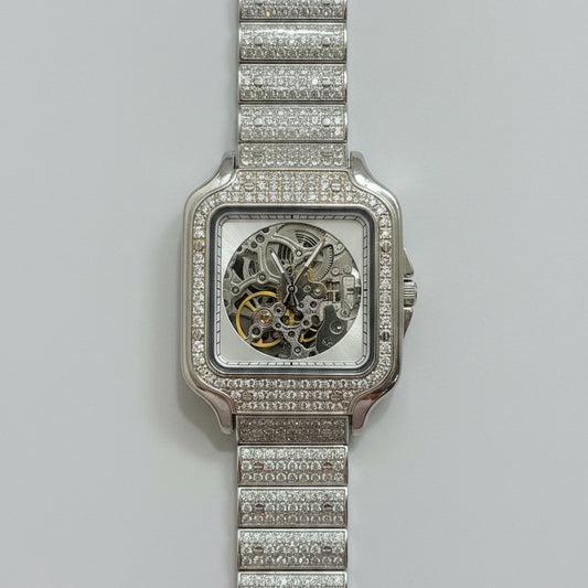 Silver watch with diamond-studded band on a red fabric background