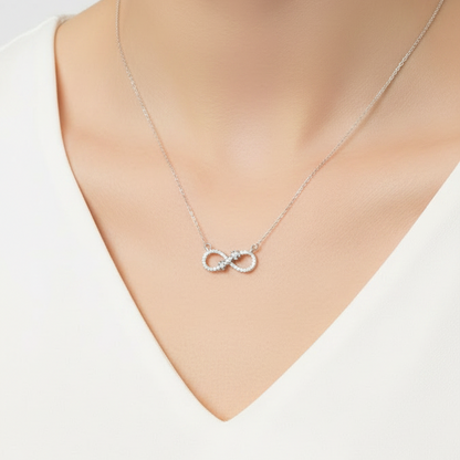Silver necklace with a clasp in a black jewelry box on a red fabric background