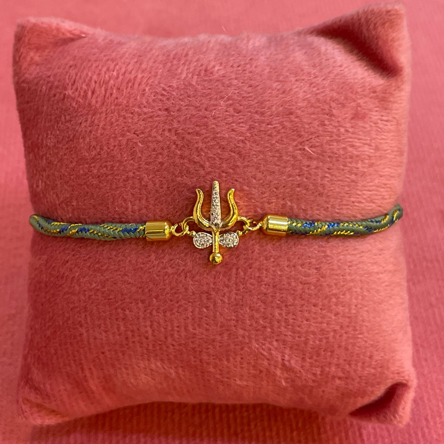 Silver Trishul Rakhi for Brother | Gold Plated Trishul Charm with CZ Stones on Teal Thread