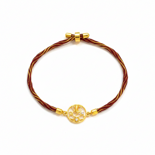 Gold Plated Ganesha Rakhi for Brother | Circular Cutwork Motif with Maroon Thread