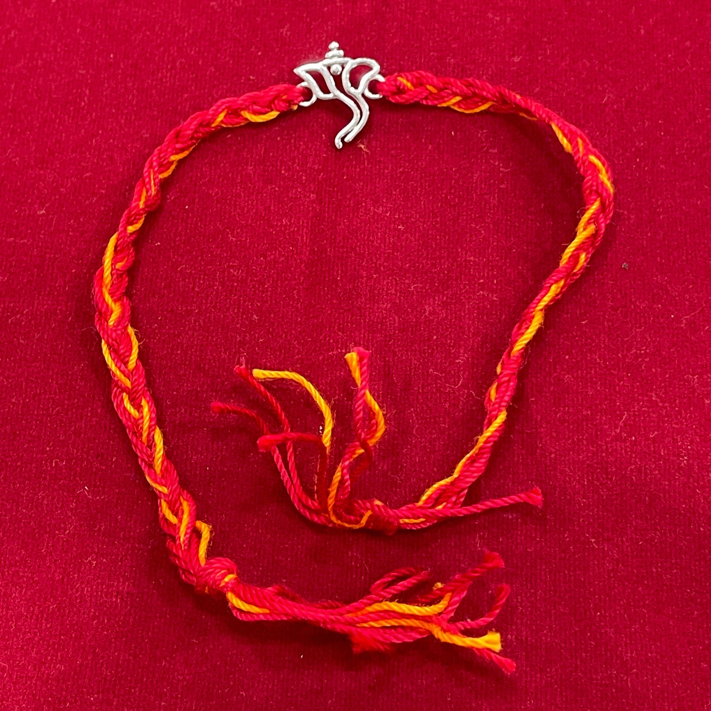 925 Sterling Silver Ganesha Face Rakhi | Red & Yellow Thread Rakhi for Raksha Bandhan