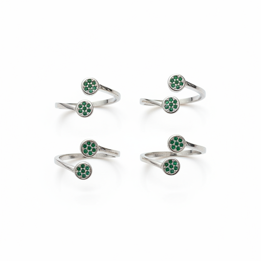 Set of silver rings with green gemstones on a white background