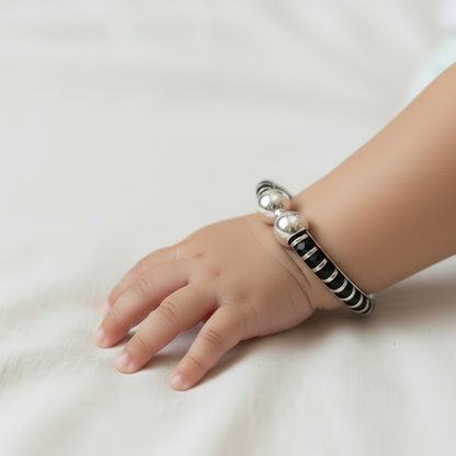 Child's hand wearing a bracelet on a white background