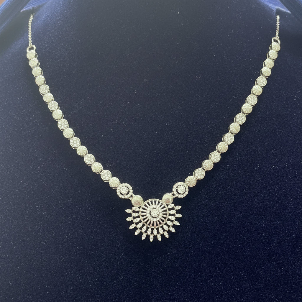 Silver necklace with a decorative clasp on a red velvet background