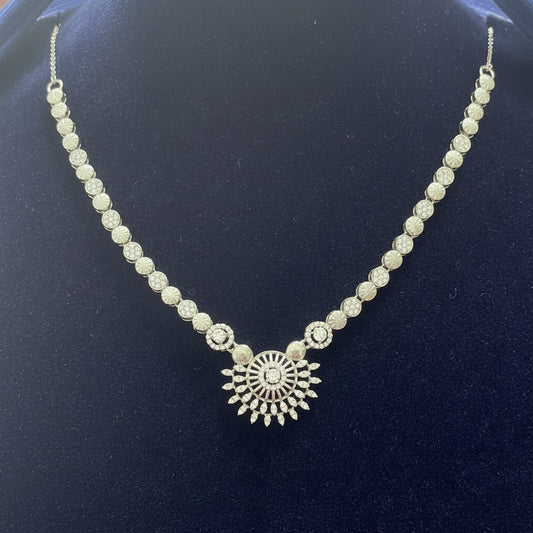Silver necklace with a decorative clasp on a red velvet background