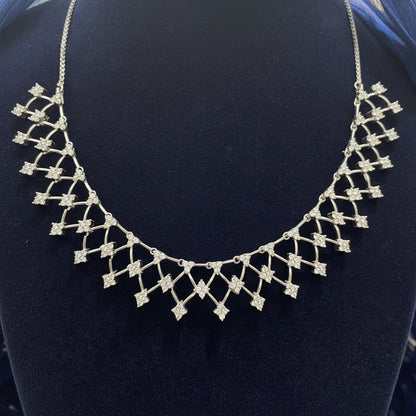 Silver necklace on a red fabric background