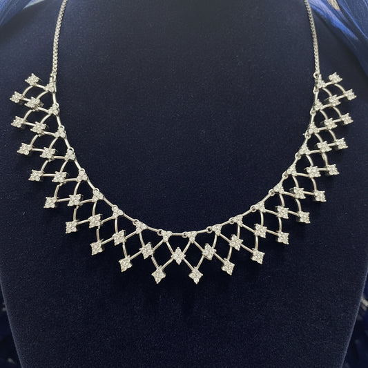 Silver necklace on a red fabric background