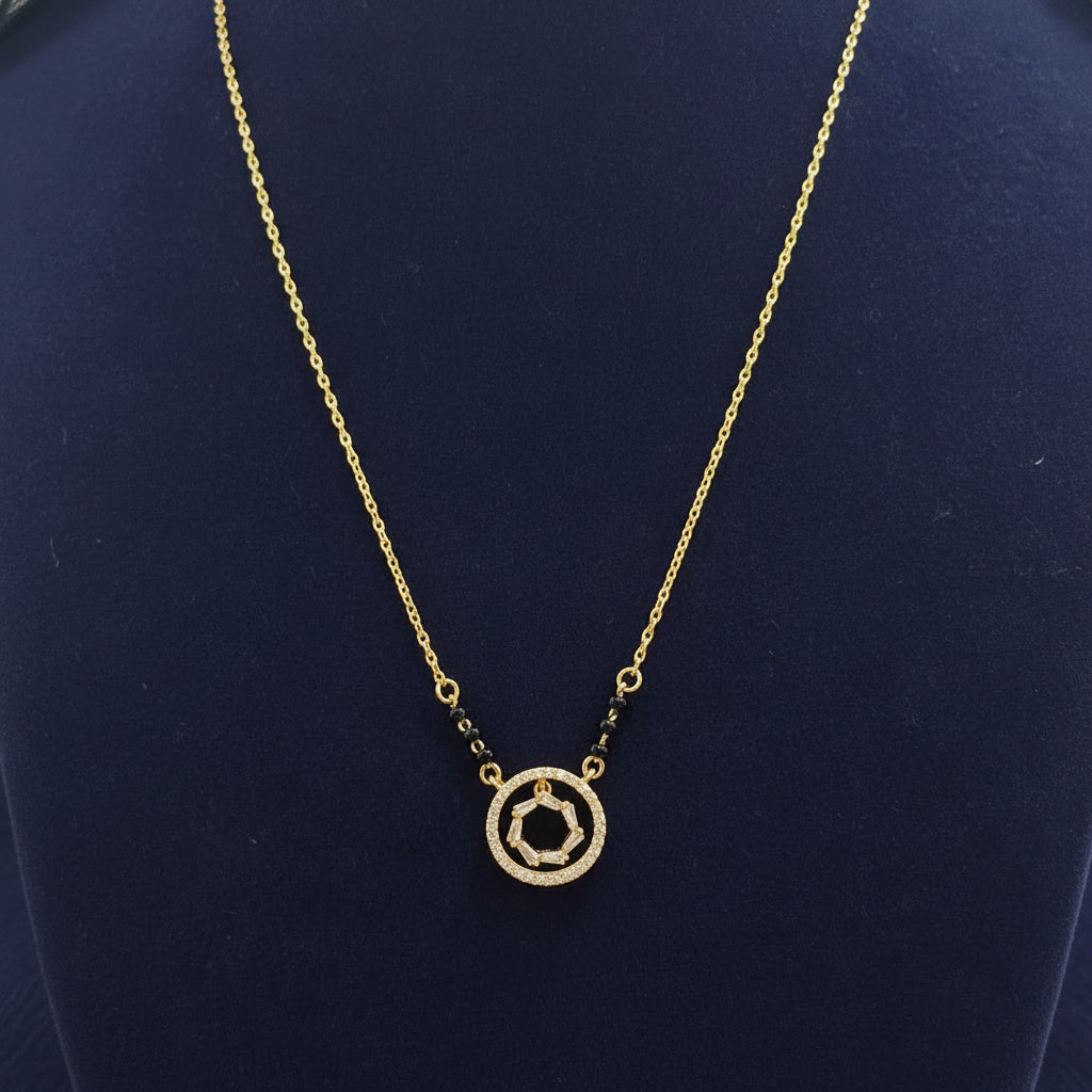 Gold necklace with a circular pendant on a red fabric background