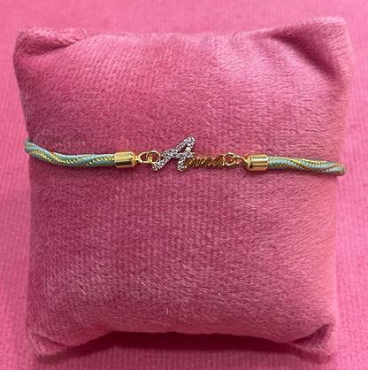 Gold-Plated Name Rakhi for Brother | CZ Script Charm on Teal & Gold Twisted Thread