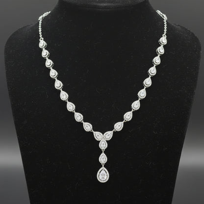 Silver necklace with a teardrop pendant on a red velvet background