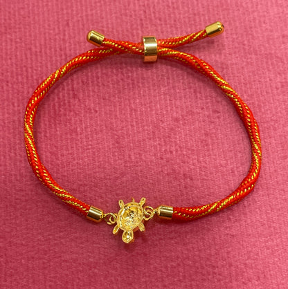 Gold-Plated Rakhi for Brother | Lucky Tortoise Charm on Red & Gold Silk Thread