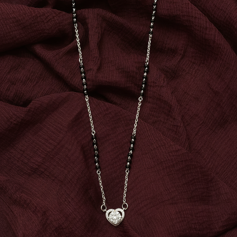 Necklace with a heart pendant on a red fabric background