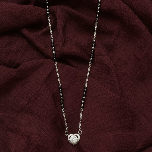 Necklace with a heart pendant on a red fabric background